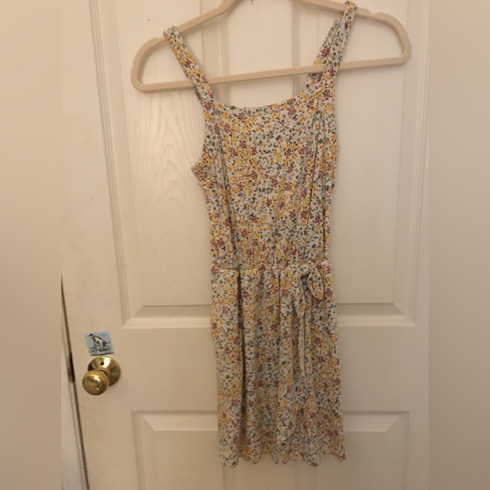 Cute jumper flows in the wind, has floral print.